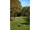 Scenic golf course with mature trees, sand traps, and golfers in action at 1216 Barcroft Pl, Raleigh, NC 27615