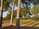 Tranquil view of a golf course with mature trees casting shadows, showcasing a peaceful outdoor setting at 1216 Barcroft Pl, Raleigh, NC 27615