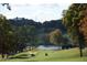 Beautiful community golf course, with a tranquil pond and mature trees in the background at 1216 Barcroft Pl, Raleigh, NC 27615