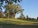 Scenic view of the community golf course with rolling hills and mature trees at 1216 Barcroft Pl, Raleigh, NC 27615