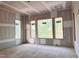 Unfinished room featuring newly installed windows showcasing green space outside at 1216 Barcroft Pl, Raleigh, NC 27615