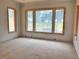 Unfinished living room showcasing large windows overlooking lush greenery, and natural light at 1216 Barcroft Pl, Raleigh, NC 27615