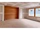 Spacious room showing windows, a wood wall, and construction in progress at 1216 Barcroft Pl, Raleigh, NC 27615