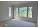 Bright living room with large windows offering scenic views of backyard at 1216 Barcroft Pl, Raleigh, NC 27615