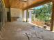 Covered patio featuring wood ceiling and views of the backyard construction and verdant lawn at 1216 Barcroft Pl, Raleigh, NC 27615