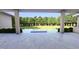 View from covered porch onto backyard featuring a pool, patio, privacy, and beautiful mature landscaping at 1216 Barcroft Pl, Raleigh, NC 27615