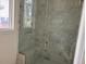 Beautiful shower with marble tiles, a built-in bench, and glass door at 1216 Barcroft Pl, Raleigh, NC 27615