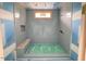 New shower with blue tiled walls, a built in seat, a window, and taped seems and floor at 1216 Barcroft Pl, Raleigh, NC 27615