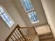 The staircase is illuminated by natural light coming from the windows above at 1216 Barcroft Pl, Raleigh, NC 27615