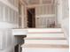 Interior view of newly constructed staircase with natural wood steps at 1216 Barcroft Pl, Raleigh, NC 27615