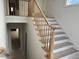A modern staircase with light wood railings and white risers leads to the upper level at 1216 Barcroft Pl, Raleigh, NC 27615