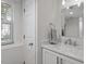 Bright bathroom featuring a marble countertop, a large mirror, and a window offering natural light at 1417 Hathaway Rd, Raleigh, NC 27608