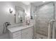 Bathroom with marble countertops, double sinks, glass shower, and modern fixtures at 1417 Hathaway Rd, Raleigh, NC 27608