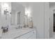 Well-lit bathroom with a sleek quartz countertop vanity and stylish sconces at 1417 Hathaway Rd, Raleigh, NC 27608