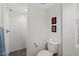 Modern bathroom with white tile, sleek fixtures, and a patterned tile floor at 1417 Hathaway Rd, Raleigh, NC 27608