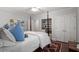 Bright bedroom featuring a four poster bed, hardwood floors, and ample storage space at 1417 Hathaway Rd, Raleigh, NC 27608