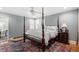 Bedroom with a four-poster bed, plush bedding, and a vibrant rug, creating a cozy ambiance at 1417 Hathaway Rd, Raleigh, NC 27608