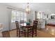 Bright dining area features natural light, hardwood floors, stylish chairs, and a view into the kitchen at 1417 Hathaway Rd, Raleigh, NC 27608
