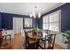 Elegant dining room featuring navy walls, white trim, hardwood floors, and refined traditional furnishings at 1417 Hathaway Rd, Raleigh, NC 27608