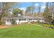Charming ranch home with a well-manicured lawn and mature trees, providing excellent curb appeal at 1417 Hathaway Rd, Raleigh, NC 27608