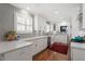 Modern kitchen with white cabinets, gray subway tile, stainless steel appliances, and hardwood floors at 1417 Hathaway Rd, Raleigh, NC 27608
