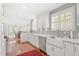 Bright kitchen with white cabinets, subway tile backsplash, stainless steel appliances, and hardwood floors at 1417 Hathaway Rd, Raleigh, NC 27608