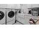 Well-equipped laundry room featuring modern appliances and ample counter space at 1417 Hathaway Rd, Raleigh, NC 27608