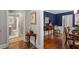 Interiors showing hardwood floors, neutral paint, and a glimpse into a room painted with a blue color palette at 1417 Hathaway Rd, Raleigh, NC 27608