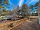 Spacious wooden deck with decorative railings, offering a private space for outdoor relaxation and wooded views at 1481 Country Club Rd, Roxboro, NC 27574
