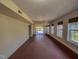 Basement area with neutral paint, laminate flooring, several windows and a door to outside at 1481 Country Club Rd, Roxboro, NC 27574