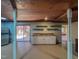 Finished basement area with white cabinets, stainless steel refrigerator, and outdoor access at 1481 Country Club Rd, Roxboro, NC 27574