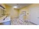 Bright bathroom with double sinks, tub with marble backsplash, and tile floors at 1481 Country Club Rd, Roxboro, NC 27574