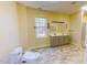 Well-lit bathroom featuring a double vanity, ceramic tile floors, and modern fixtures at 1481 Country Club Rd, Roxboro, NC 27574