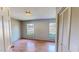 Well-lit bedroom featuring hardwood flooring, light-colored walls, and two windows at 1481 Country Club Rd, Roxboro, NC 27574