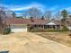 Charming single-story brick home with mature landscaping and attached garage at 1481 Country Club Rd, Roxboro, NC 27574