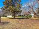 Charming brick home with a well-manicured lawn and mature trees, creating a welcoming curb appeal at 1481 Country Club Rd, Roxboro, NC 27574