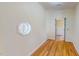 Hallway featuring hardwood flooring and a unique octagon window at 1481 Country Club Rd, Roxboro, NC 27574