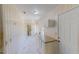 Long kitchen with bright white cabinets, marble-style floors, and good lighting at 1481 Country Club Rd, Roxboro, NC 27574