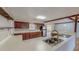 Kitchen featuring ample cabinet space, a stainless refrigerator, and hardwood floors at 1481 Country Club Rd, Roxboro, NC 27574
