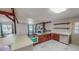 Well-lit kitchen with marble floors, wooden cabinets, and stainless steel oven stove, seamlessly connected to living area at 1481 Country Club Rd, Roxboro, NC 27574