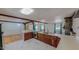 Open concept kitchen with marble flooring, a sink, and dark wood cabinets at 1481 Country Club Rd, Roxboro, NC 27574