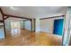 Living room with hardwood floors, natural light, and a striking blue front door at 1481 Country Club Rd, Roxboro, NC 27574