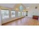 Sun-filled living room boasts high ceilings, hardwood floors, large windows, and ornate wall lighting at 1481 Country Club Rd, Roxboro, NC 27574