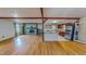 Spacious open-concept with hardwood floors, stone fireplace, a kitchen with white countertops and cherry cabinetry at 1481 Country Club Rd, Roxboro, NC 27574