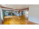 Open-concept living room featuring a stone fireplace, hardwood floors, and exposed beams, perfect for gatherings at 1481 Country Club Rd, Roxboro, NC 27574
