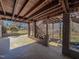 View of a covered patio with brick columns, wood ceiling, and outdoor access at 1481 Country Club Rd, Roxboro, NC 27574