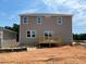 New two-story home with a backyard deck and a separate unfinished detached one-car garage, enhancing outdoor living at 15 Atherton Circle, Angier, NC 27501