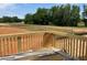 View from the wooden deck showcasing the surrounding neighborhood and green spaces at 15 Atherton Circle, Angier, NC 27501