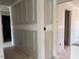 Unfinished hallway featuring multiple doorways, providing connectivity to various rooms in an unfinished home at 15 Atherton Circle, Angier, NC 27501
