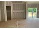 An unfinished living room featuring drywall for customization, with sliding door offering potential outdoor access at 15 Atherton Circle, Angier, NC 27501